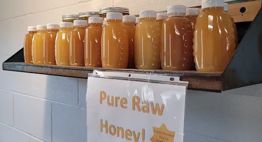 Jars of pure raw honey on a shelf in the farm store
